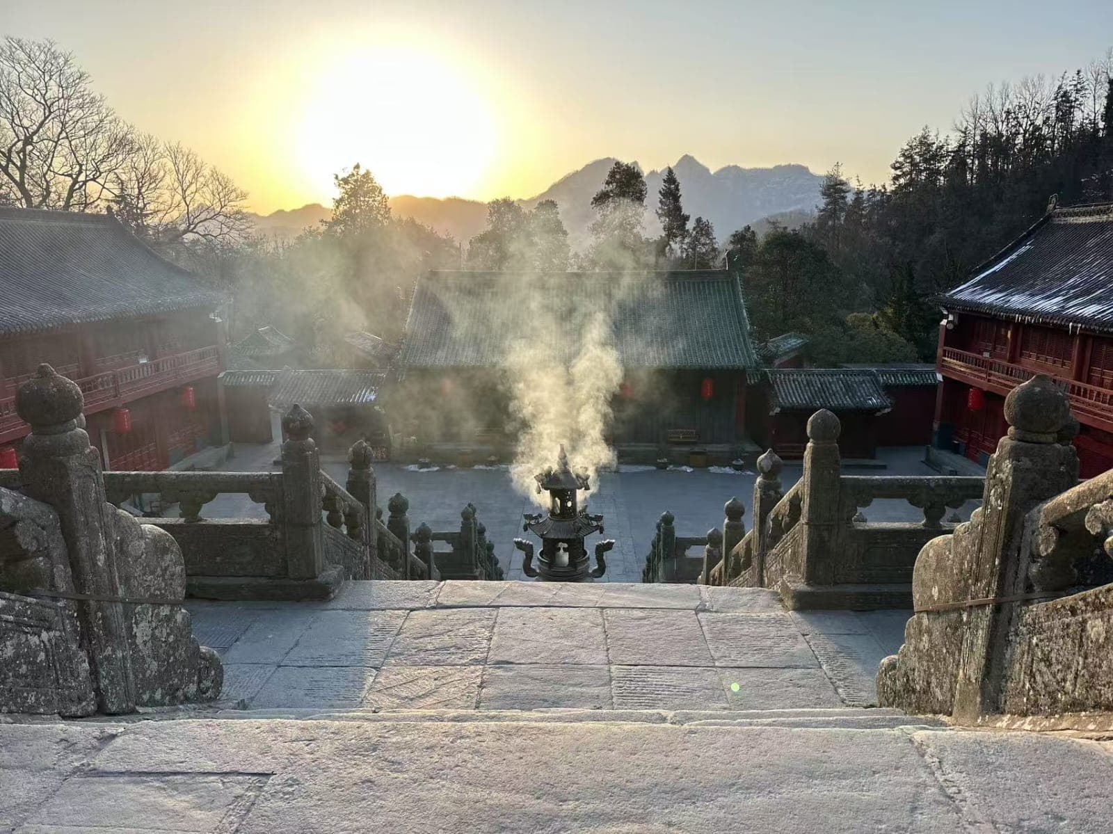 Temple with incense and mountains at sunrise